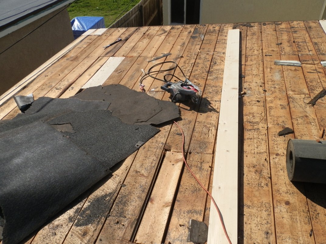 Plywood roof decking being installed on a partial re-roof in Downey.