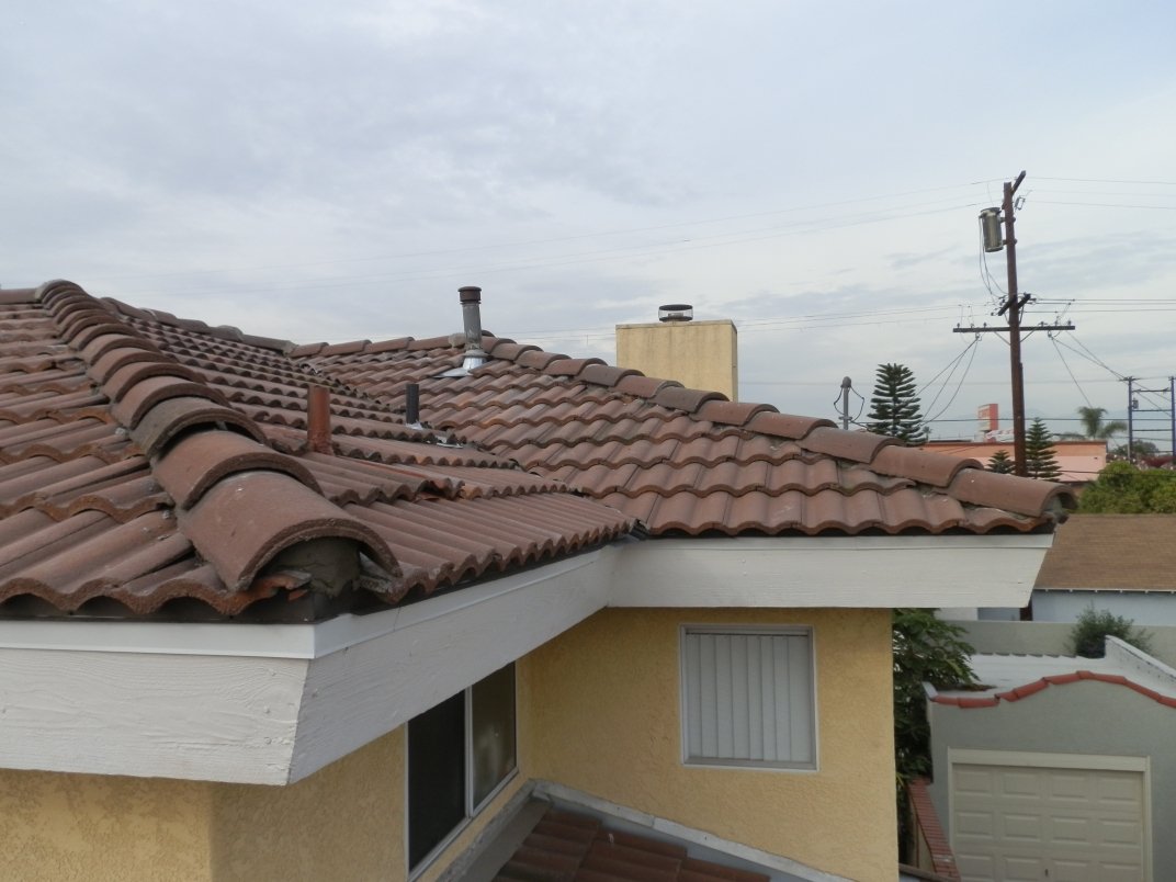 White fascia board and eave on a finished clay tile roof.
