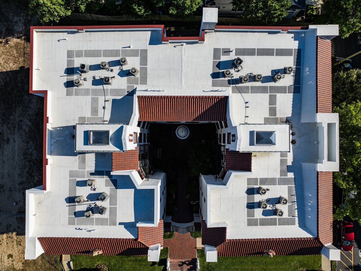 White-coated flat roof on an apartment building.