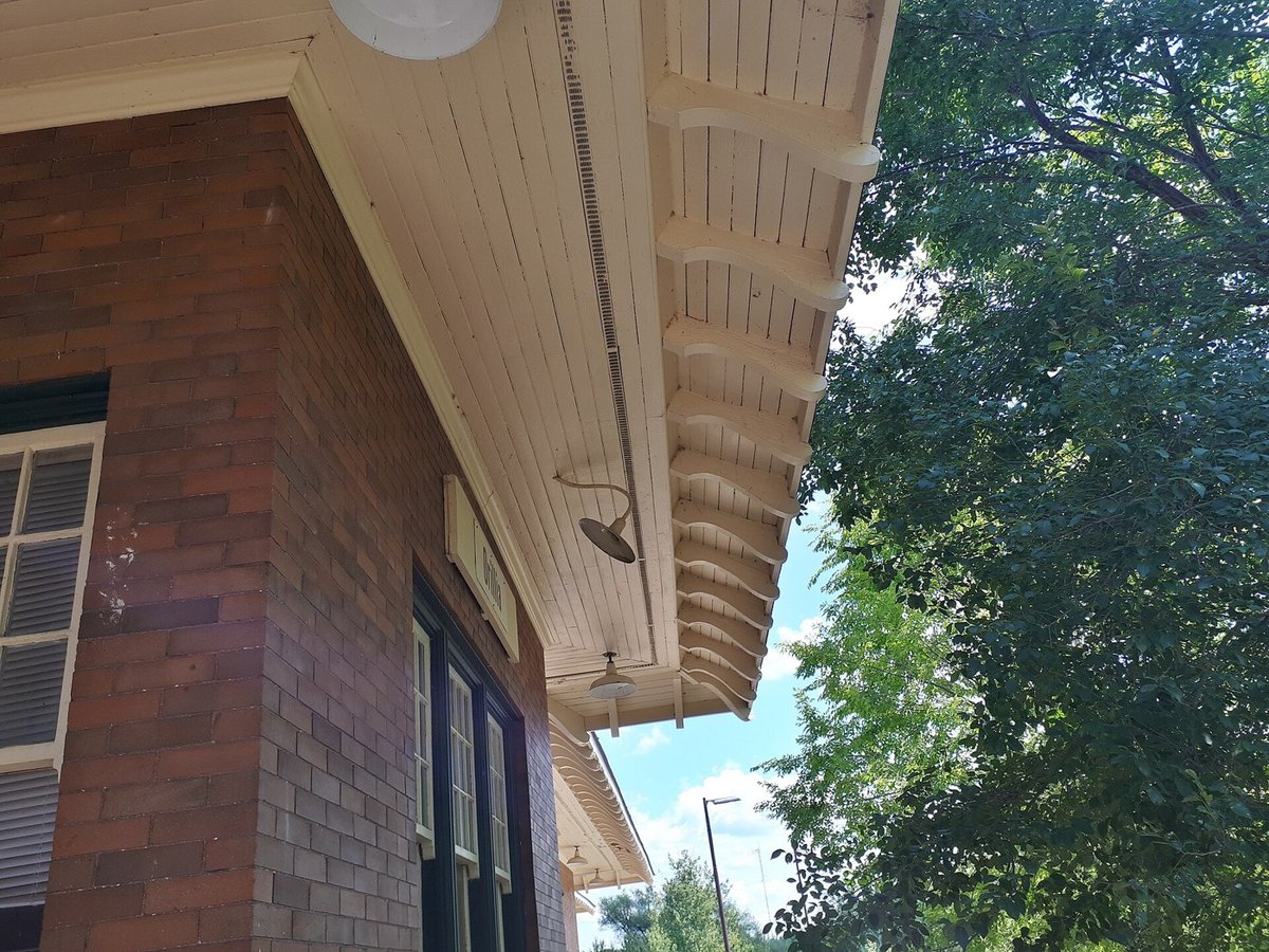 Underside of a roof overhang (soffit) on a brick building.