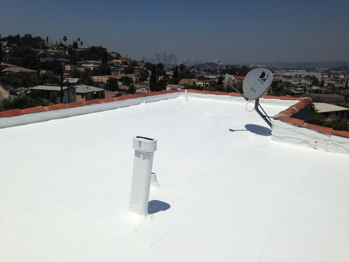 Coated flat roof with sealed vent pipe penetration